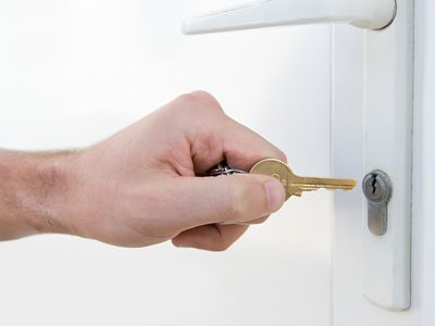 Man putting key into a lock