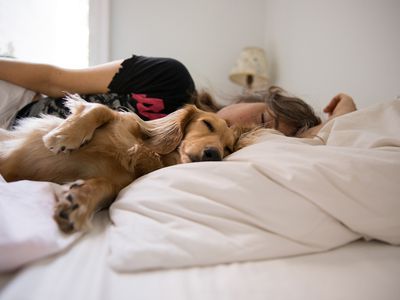 Woman laying with her dog.