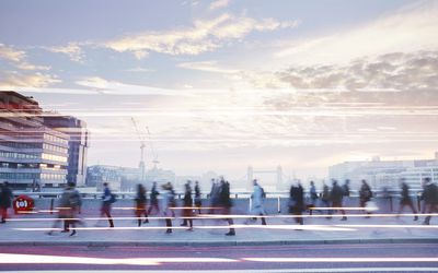 businesspeople walking through busy city street