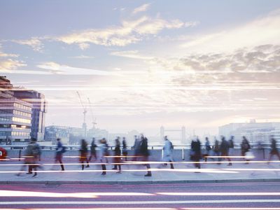 businesspeople walking through busy city street