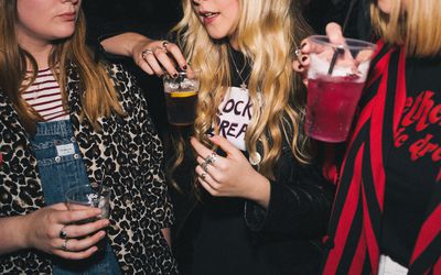 young women drinking together