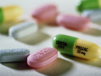 Close-up of Prozac, Paxil, and Zoloft tablets.