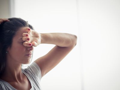 a person with their hand on forehead