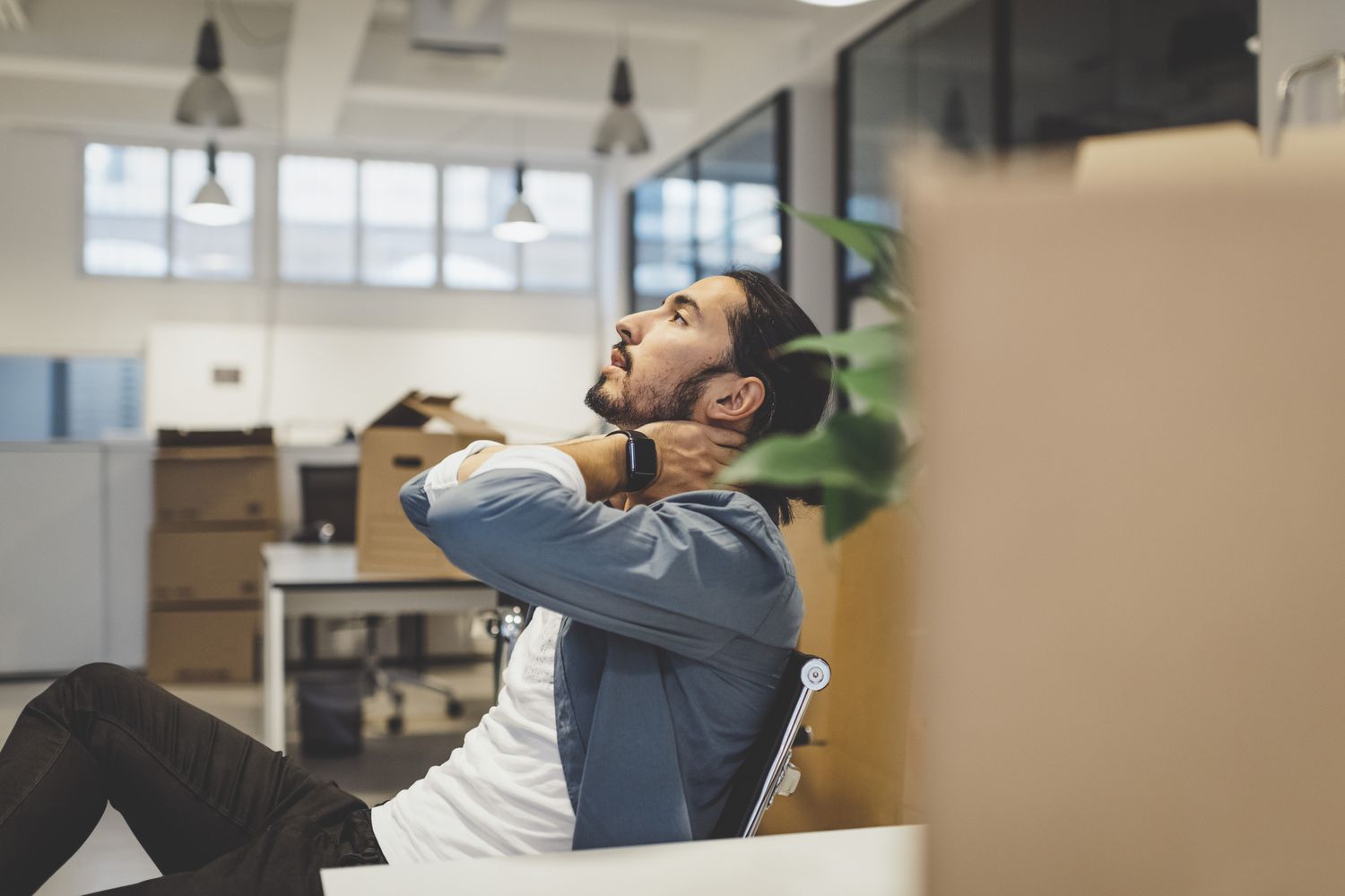 person sitting at their desk with neck pain stressed out