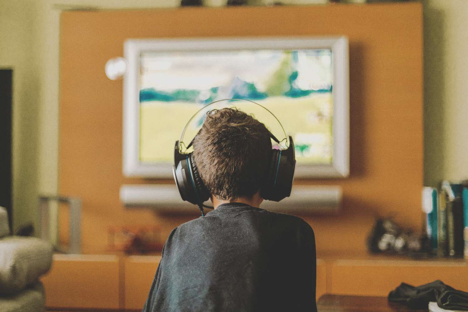 boy enjoying video game console at home