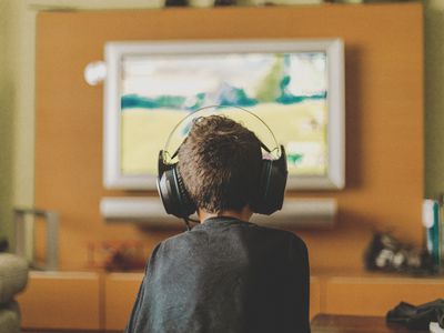 boy enjoying video game console at home