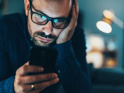 Man looking irritated at his phone