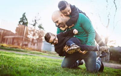 Dad playing with his kids outside