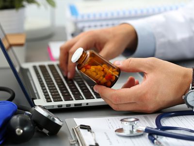 Male medicine doctor hands hold jar of pills