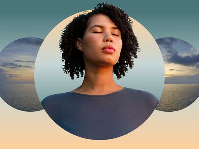 Woman with curly hair meditating against ocean backdrop