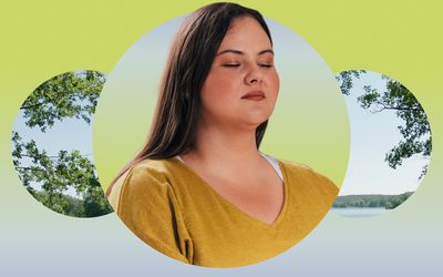 Woman meditating against a scenic overlook