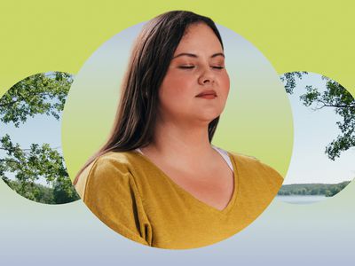 Woman meditating against a scenic overlook