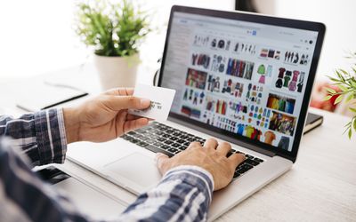 Man with laptop and credit card shopping online