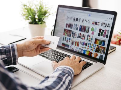 Man with laptop and credit card shopping online