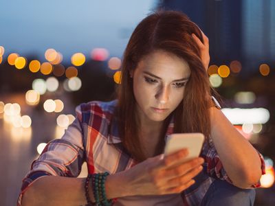 Unhappy woman texting at the bridge