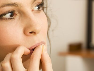 Woman biting her nails