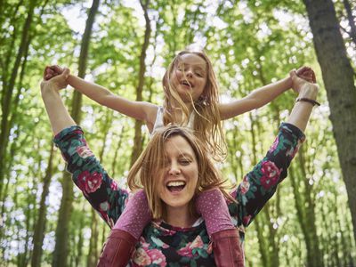 Woman with daughter on her shoulders