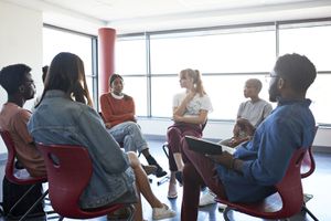 Sad woman sharing with friends and instructor