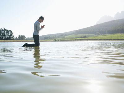 a man praying in the water