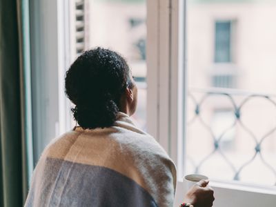 Sad BIPOC woman looking out the window