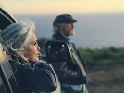 older woman looking out the window in her car at natural spendor