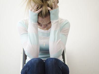 Woman holding her head and very stressed