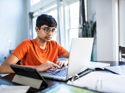 Teen on computer facetiming psychologist 