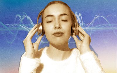 Woman listening to binaural beats on headphones