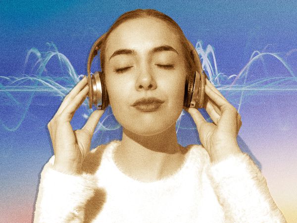 Woman listening to binaural beats on headphones