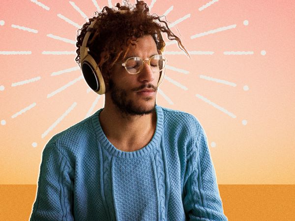 a closed eyed black guy with headphones on 