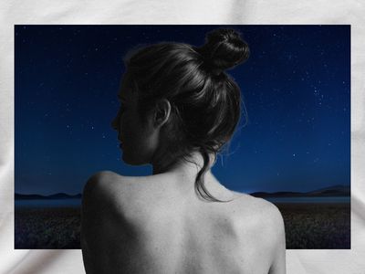 woman in a dreamlike landscape at night