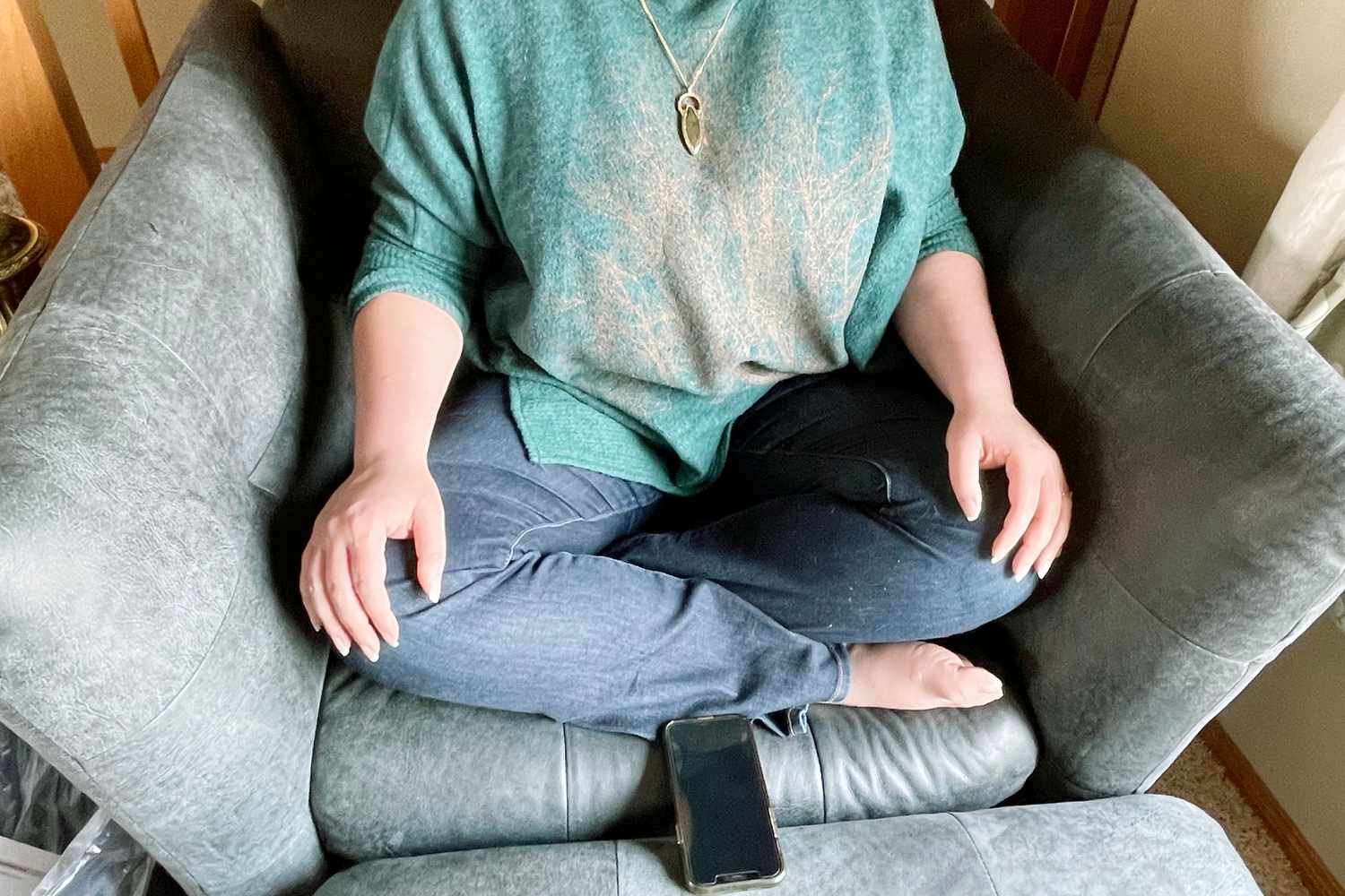 An individual meditating on a chair