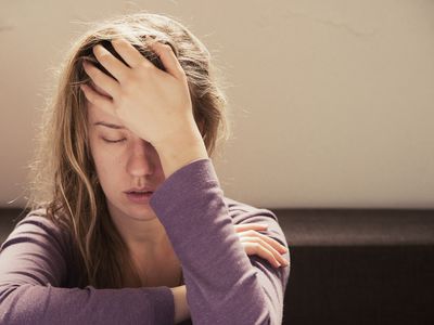 distressed woman with hand on her head