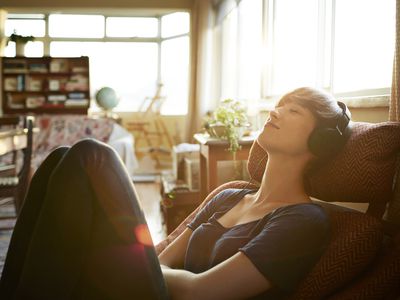 Young woman relaxing with headphones at home